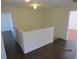 Shows an upstairs hallway with dark hardwood floors and a half wall at 7423 Pulteney Dr, Zephyrhills, FL 33545