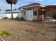 Backyard featuring white fence, patio area, and outdoor seating for relaxation and entertainment at 988 Bruce Ave, Clearwater Beach, FL 33767