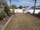 Large backyard space ready for customization, enhanced by a privacy fence and mature trees at 988 Bruce Ave, Clearwater Beach, FL 33767
