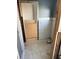 Tiled bathroom area with partially exposed framing leading into another room at 988 Bruce Ave, Clearwater Beach, FL 33767