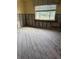 Spacious room with a large window providing natural light and exposed framework on the walls at 988 Bruce Ave, Clearwater Beach, FL 33767