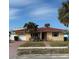 Charming single-story home with a red tile roof, well-manicured lawn, and inviting curb appeal at 988 Bruce Ave, Clearwater Beach, FL 33767
