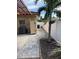 Side of house with brick walkway leading to an outdoor shower and fenced-in yard at 988 Bruce Ave, Clearwater Beach, FL 33767