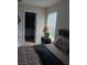 Bedroom with a closet, window with blinds, and a bedside table at 10319 Boyette Creek Blvd, Riverview, FL 33569