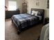 This bedroom features a cozy bed, a dresser, carpet, and a shelving unit at 10319 Boyette Creek Blvd, Riverview, FL 33569
