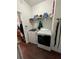 A modern laundry room featuring wood vinyl floors, white paint, and modern washer and dryer machines at 10319 Boyette Creek Blvd, Riverview, FL 33569