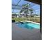 A screened in backyard pool featuring a built-in jacuzzi and beautiful backyard scenery at 10319 Boyette Creek Blvd, Riverview, FL 33569