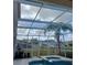 This screened-in pool has an attached jacuzzi and views of the community at 10319 Boyette Creek Blvd, Riverview, FL 33569