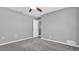 Bright bedroom with ceiling fan and door to hallway at 10433 Isleworth Ave, Tampa, FL 33647