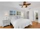 King-size bed, ceiling fan, and windows in a bright, airy bedroom at 105 Aspen Cir # 105, Seminole, FL 33777