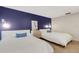 Two twin beds in a bedroom with a blue accent wall at 107 Fernwood Cir # 107, Seminole, FL 33777