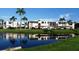 Condo building with water view and lush landscaping at 107 Fernwood Cir # 107, Seminole, FL 33777