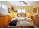 Cozy bedroom featuring wicker furniture, floral bedding, and plantation shutters at 112 Silverbell Ct, Sun City Center, FL 33573