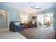 Cozy living room with sliding glass doors leading to a screened porch at 112 Silverbell Ct, Sun City Center, FL 33573