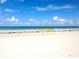White sandy beach with a roped-off area and clear blue sky at 11300 7Th E St, Treasure Island, FL 33706