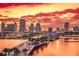 Vibrant sunset over a cityscape with a pier extending into the water at 11300 7Th E St, Treasure Island, FL 33706