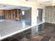 Large living room with tiled floors and sliding glass doors leading to a patio at 11300 7Th E St, Treasure Island, FL 33706
