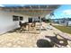 Covered patio with outdoor dining area and water view at 11300 7Th E St, Treasure Island, FL 33706