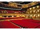 Large theater with red seats and stage lighting at 11300 7Th E St, Treasure Island, FL 33706