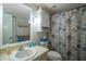 Bathroom with seashell shower curtain and vanity at 11485 Oakhurst Rd # A203, Largo, FL 33774