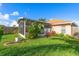 Landscaped backyard with a screened patio and lush greenery at 12518 Midpointe Dr, Riverview, FL 33578