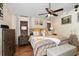 Bright main bedroom with king-size bed and wood floors at 12518 Midpointe Dr, Riverview, FL 33578