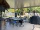 Spacious screened porch with seating, dining table, a grill, and backyard views at 137 Sw Lincoln N Cir, St Petersburg, FL 33703