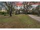 Charming house nestled on a large lot with mature trees at 1406 Butch Cassidy Trl, Wimauma, FL 33598