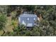 Home with solar panels, screened pool, and lush landscaping at 1406 Butch Cassidy Trl, Wimauma, FL 33598