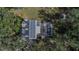 An aerial view of a house with solar panels, pool, and a shed at 1406 Butch Cassidy Trl, Wimauma, FL 33598