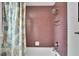 Bathroom with mauve tile and shower/tub combo at 1406 Butch Cassidy Trl, Wimauma, FL 33598