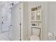 Small half bathroom with toilet and storage cabinet at 1406 Butch Cassidy Trl, Wimauma, FL 33598