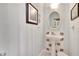 Small half bathroom with pedestal sink and decorative tile at 1406 Butch Cassidy Trl, Wimauma, FL 33598