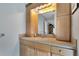 Bathroom with light wood cabinets, a sink and a large mirror at 1406 Butch Cassidy Trl, Wimauma, FL 33598
