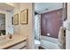 Clean bathroom with mauve tile, shower/tub combo, and vanity at 1406 Butch Cassidy Trl, Wimauma, FL 33598