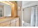 Bathroom with a shower, tile flooring and light wood cabinets at 1406 Butch Cassidy Trl, Wimauma, FL 33598
