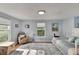 Serene bedroom with light-blue walls, wood floors, and a daybed at 1406 Butch Cassidy Trl, Wimauma, FL 33598