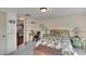 Bedroom with leafy bedding, sitting area, and access to another room at 1406 Butch Cassidy Trl, Wimauma, FL 33598