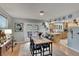 Bright dining room with wooden table and access to backyard patio at 1406 Butch Cassidy Trl, Wimauma, FL 33598