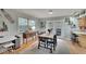 Charming dining area with wooden table, french doors, and hardwood floors at 1406 Butch Cassidy Trl, Wimauma, FL 33598