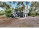 Charming two-story home with inviting stairway, porch, and mature landscaping on a spacious lot at 1406 Butch Cassidy Trl, Wimauma, FL 33598