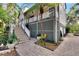Elevated home with a wrap around porch and lush landscaping at 1406 Butch Cassidy Trl, Wimauma, FL 33598
