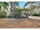 Cute cottage with a metal roof, mature landscaping, and a spacious yard at 1406 Butch Cassidy Trl, Wimauma, FL 33598