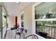 Relaxing front porch with seating area and view of lush landscape at 1406 Butch Cassidy Trl, Wimauma, FL 33598