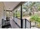 Covered front porch with wooden deck and serene wooded views at 1406 Butch Cassidy Trl, Wimauma, FL 33598