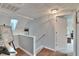 Upper level hallway with access to bedrooms and a staircase at 1406 Butch Cassidy Trl, Wimauma, FL 33598