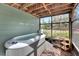 Relaxing screened-in hot tub with a view of the backyard, complete with wooden deck and storage space at 1406 Butch Cassidy Trl, Wimauma, FL 33598