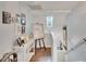 Upper level landing with hardwood floors, art display, and staircase at 1406 Butch Cassidy Trl, Wimauma, FL 33598