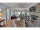 Relaxing living room with hardwood floors, fireplace and access to entryway at 1406 Butch Cassidy Trl, Wimauma, FL 33598