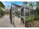Screened pool with deck and lounge chairs at 1406 Butch Cassidy Trl, Wimauma, FL 33598